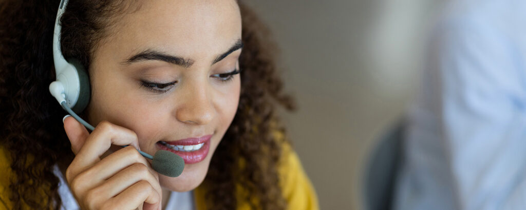 A customer service rep talking on headphones